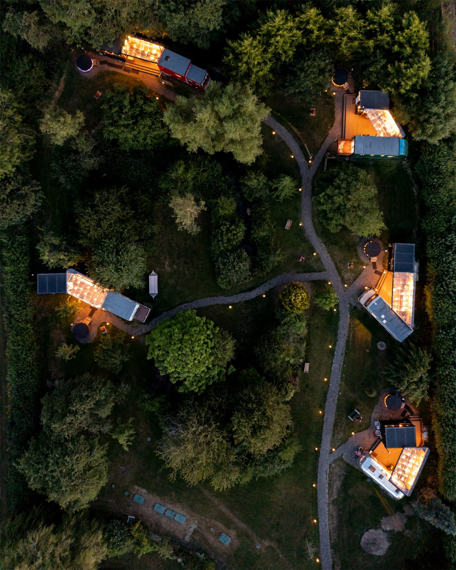 Guests in front of an Airstream, toasting marshmallows over a VW camper shaped fire pit.