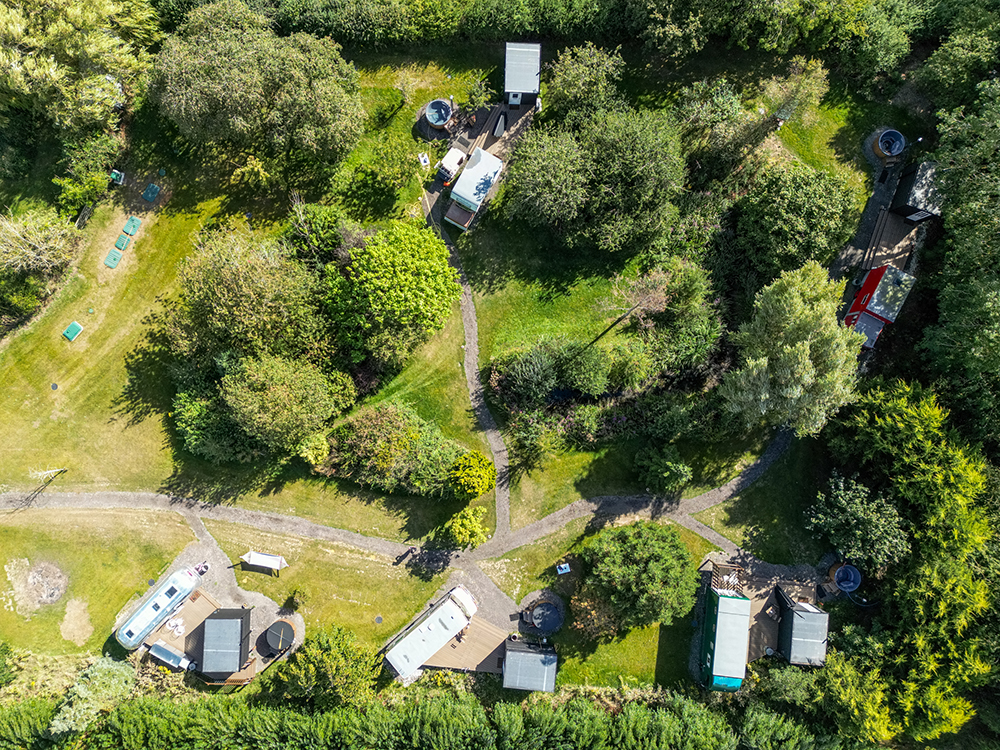 Overhead shot of the site showing the vehicles, decks, bathrooms and hot tubs.